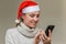 Young girl in santa claus hat talking on video communication with her friend