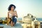 Young girl with saxophone on the roof parapet.