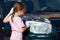 Young Girl Scrubs Car Headlight