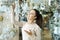 Young girl selecting chandelier for interior