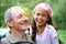 A young girl sharing a joke with her grandfather