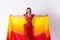 Young girl with shawl and in red dress performs oriental dance on white background