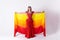 Young girl with shawl and in red dress performs oriental dance on white background