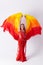 Young girl with shawl and in red dress performs oriental dance on white background