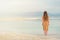 Young girl with shining blonde hair goes to seaside, Dead Sea beach. Banner. Travel, summer vacation, holiday, freedom concept.