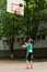 Young girl shooting a goal in basketball