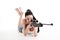 Young girl shoots with a sniper rifle.