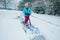 A young girl shoveling snow in a winter storm