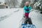 A young girl shoveling snow in a winter storm