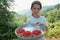 Young girl show me some basket full of wild strawberries, local fruit of Tresnjevik mountain between Andrijevica and Kolasin