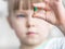 Young girl showing off her chewable vitamin c tablet