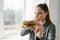 A young girl shows that she does not like a burger. Conceptual image of refusal from unhealthy eating.