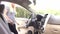 Young girl sits in car in the front driver`s seat.