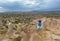 A young girl sits on a cliff in Cappadocia and looks at the horizon and blue sky