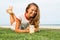 The young girl sits on a grass in the tropical country of the island Samui, the Girl drinks smoothie.