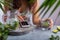 A young girl sits at a table with lemonade in her hand and looks into the phone