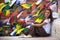 Young girl sitting on Buddhist stupa, prayer flags flying in background. Travel.