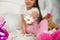 Young girl sitting on her bed with flower.