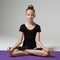 A young girl is sitting in a lotus pose. Meditation. Child.