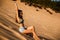 Young girl sitting on a sand dune