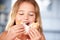 Young Girl Sitting At Table Eating Sugary Donut