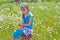 Young girl sitting on a wooden barrel