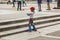 Young girl skater in foreground adjusts her protective gloves w