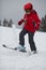 Young girl skier tosses up snow