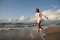 Young girl skipping on the beach