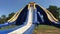 Young girl sliding down at giant inflatable slide