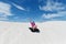 Young girl  sliding down on Lancelin sand dunes Western Australi