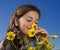 Young girl smelling flowers