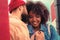 Young girl smiling while kind boyfriend whispering romantic words to her