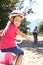 Young girl smiling riding bike with mom