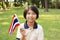Young girl smiling and waving Thailand flag