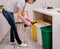 Young girl sorting garbage at the kitchen. Concept of recycling. Zero waste