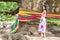 Young girl standing in front of a Giant Monkeypod Tree