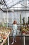 Young girl standing in a glass house full of cacti