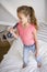 Young Girl Standing On Her Bed