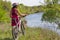 Young girl standing near bike in the sports shock-helmet. Summer tourism