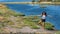 Young girl standing on one leg in front of flamingos