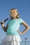 Young girl standing on tennis court Holding Tennis Racket portrait low angle view