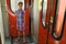 Young girl standing in vestibule of train and hold