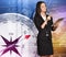 Young girl stands on background compass pressing