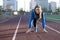 Young girl stands at the start on a treadmill, woman runner exercise on the street