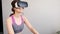 Young girl stay home in quarantine and go in for sports with virtual reality glasses. Woman exercise yoga while home