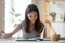 Young girl student busy studying with book at home