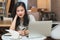 Young girl studying at home. University Women student learn and research from internet and take a note by e-learning program