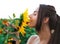 Young girl at the sunflowers portrait sniffing it