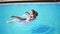 young girl with sunglasses, coctail and dreads on the inflatable rubber ring posing in the swimming pool